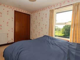A bedroom with a bed and wardrobe at Robin Hood Farmhouse in Keswick