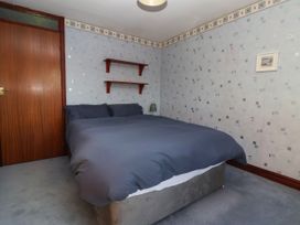 A bedroom with a bed and shelves at Robin Hood Farmhouse in Keswick