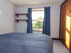 A bedroom featuring a bed and window at Robin Hood Farmhouse in Keswick
