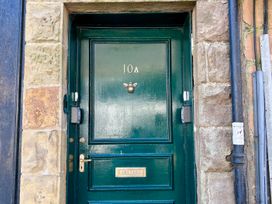 A green door with number 10A and a knocker at Downton I Alnwick