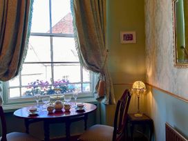 A dining room with a table set for tea at Downton I in Alnwick