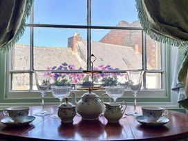 A kitchen with tea set and flowers viewed from window at Downton I Alnwick