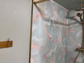 A shower with a decorative wall and a hook at Downton I in Alnwick