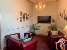 A living room with a sofa and television at Downton I Alnwick