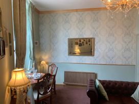 A sitting room with a table and sofa at Downton I in Alnwick