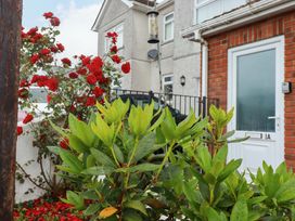 A front view of a house with flowers and greenery at Treetops in Par