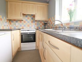 A kitchen with cupboards and an oven at Treetops in Par