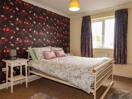 A bedroom with a bed and bedside table at Treetops in Par