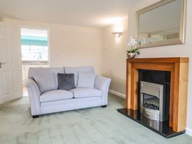 A living room with a sofa and a fireplace at Frome View Wool