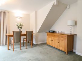 A dining room with a table and chairs at Frome View Wool