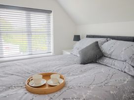 A bedroom with a bed and a tray of cups at Frome View Wool