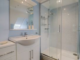 A bathroom with a sink, shower, and mirror at Frome View in Wool
