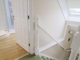 A bathroom with a shower and stairs at Frome View Wool
