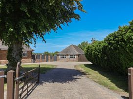 An outdoor view of a building with a driveway at Frome View in Wool