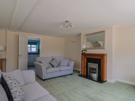 A living room with a sofa and fireplace at Frome View in Wool