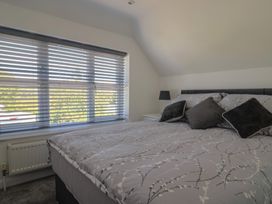 A bedroom with a bed and window at Frome View in Wool
