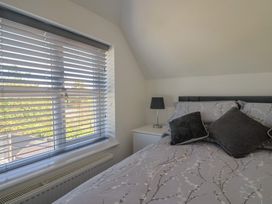 A bedroom with a bed and window at Frome View in Wool