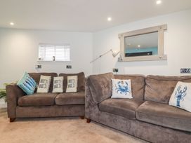 A living room with sofas and a window at 31 Tregoney Hill in Mevagissey