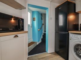 A kitchen with a microwave and fridge at 31 Tregoney Hill Mevagissey