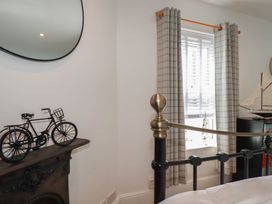 A bedroom with a bicycle on a table and a model ship at 31 Tregoney Hill Mevagissey