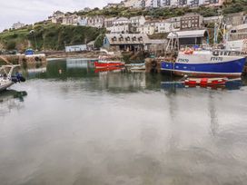 A harbor with boats and buildings at 31 Tregoney Hill in Mevagissey