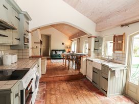 A kitchen with a sink and oven at The Coach House Cottage in BALLYCOMMON