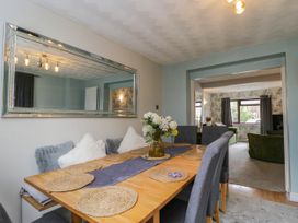 A dining room with a table set for meals at 1 Stanway Road