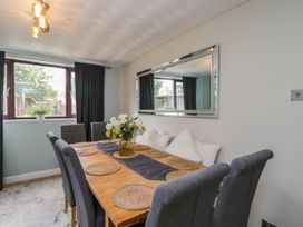 A dining room with a table and chairs at 1 Stanway Road
