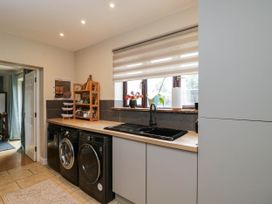 A kitchen with a sink and washing machine at 1 Stanway Road 