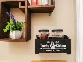 A treats station with jars and a plant in a kitchen at 1 Stanway Road