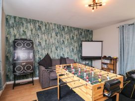 A game room with a foosball table and projector screen at 1 Stanway Road