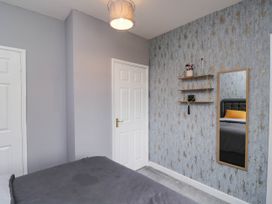 A bedroom with a bed and a mirror at 1 Stanway Road