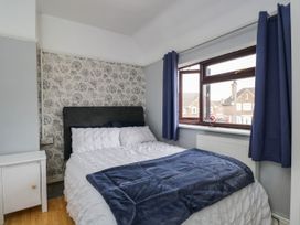 A bedroom with a bed and bedside table at 1 Stanway Road