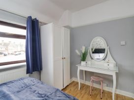 A bedroom with a wardrobe and vanity at 1 Stanway Road