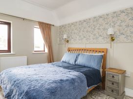 A bedroom with a bed and nightstand at 1 Stanway Road 