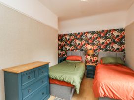 A bedroom with two beds and a dresser at 1 Stanway Road
