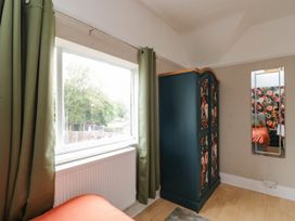A bedroom with a wardrobe and window at 1 Stanway Road