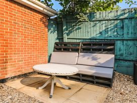 A garden with a table and sofa made from pallets at 1 Stanway Road