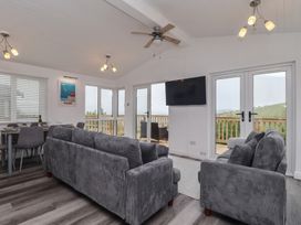 A living room with a sofa and dining table at Lodge 19 in Torpoint