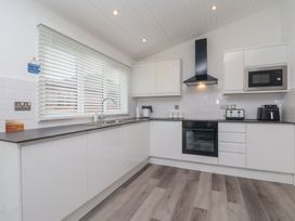 A kitchen with a sink and appliances at Lodge 19 in Torpoint