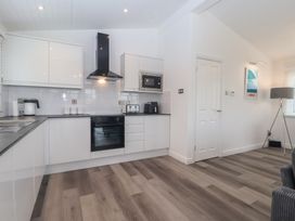 A kitchen with modern appliances at Lodge 19 in Torpoint