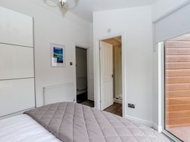 A bedroom with a bed and a door leading to a bathroom at Lodge 19 in Torpoint