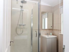 A bathroom with a shower and sink at Lodge 19 in Torpoint