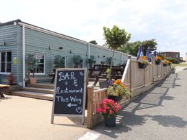 An outdoor area with a sign for the bar and restaurant at Lodge 19 in Torpoint