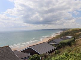 A view of the sea and beach with houses at Lodge 19 in Torpoint