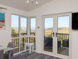 A sunroom with windows and a door at Lodge 19 in Millbrook