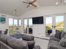A living room with a sofa and television at Lodge 19 in Millbrook