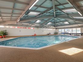An indoor pool with a ladder and seating at Lodge 19 in Millbrook