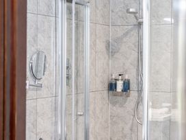 A shower with a mirror and soap dispenser at Cotswolds Apartment, sleeps 4 in Chipping Norton