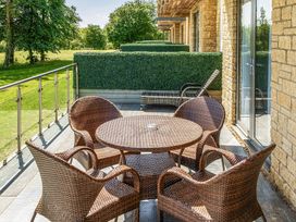 A table and chairs on an outdoor balcony at Cotswolds Apartment, sleeps 4 in Chipping Norton